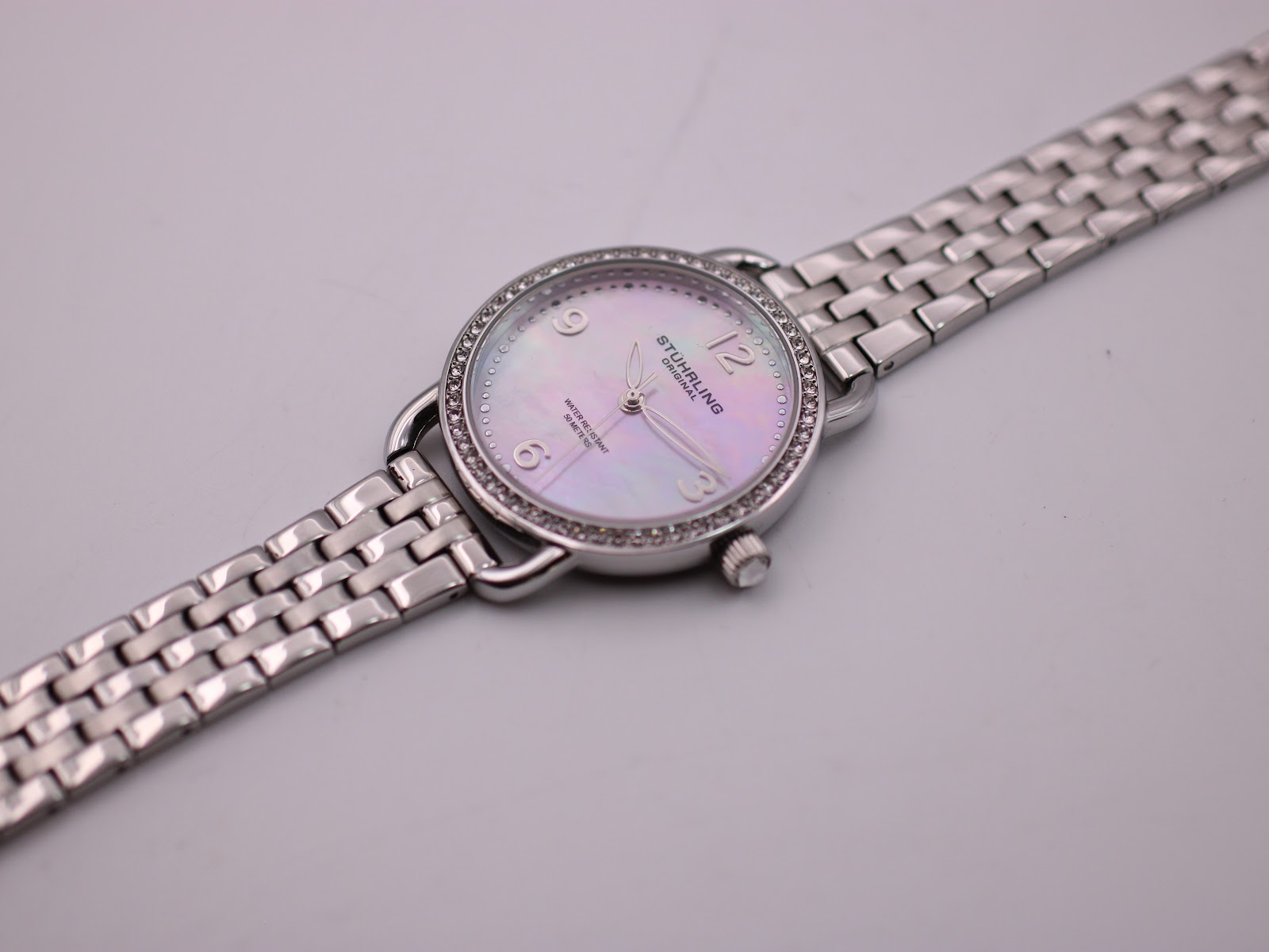 Overhead angled view of the Stührling Original watch and its stainless steel bracelet laid flat, showcasing the full length.
