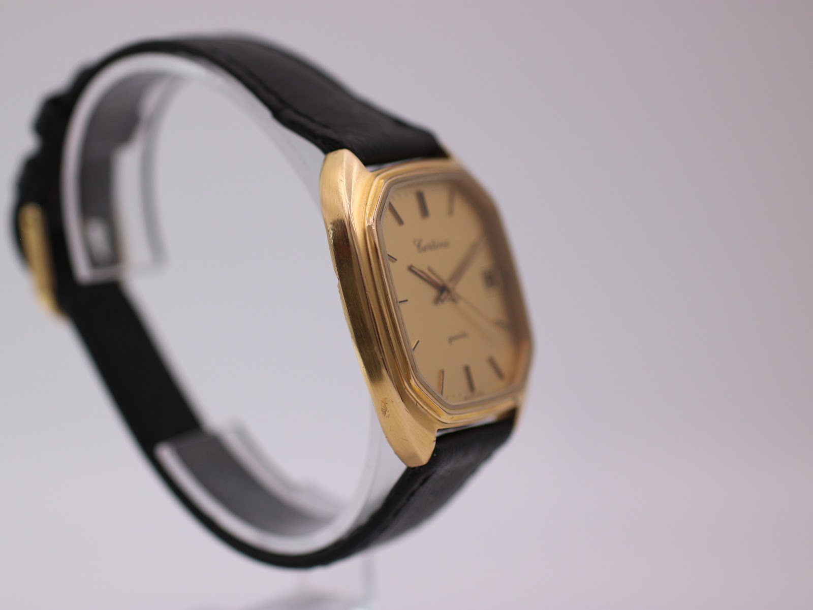 Another side angled view of the Certina Newport watch, highlighting the case profile, on a display stand.