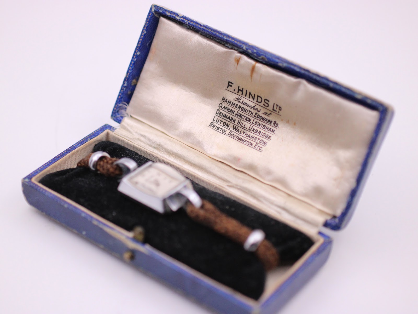 The Helvetia watch nestled inside its original vintage blue F. Hinds Ltd. presentation box, which features a satin lining.