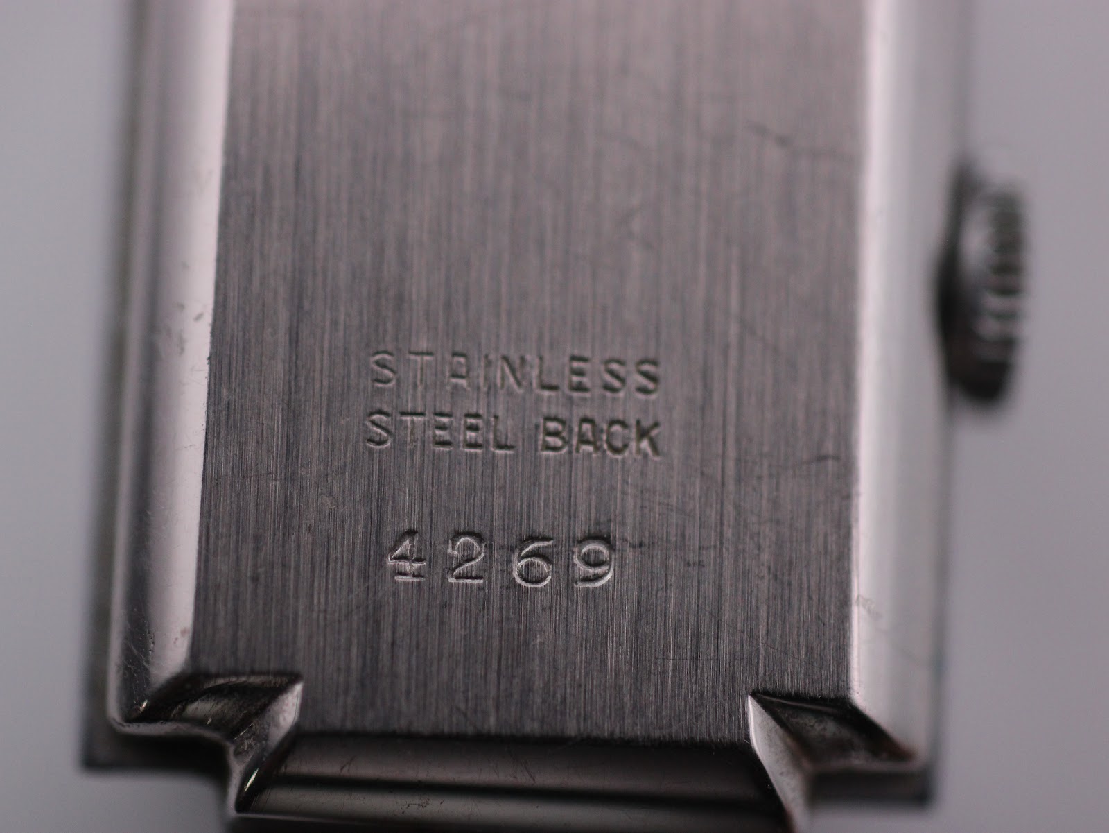 Detailed close-up of the watch's case back, clearly showing the engraved text 'Stainless Steel Back' and the serial number '4269'.