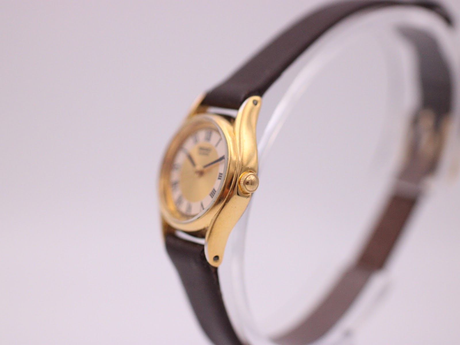 Right-side view of the Seiko watch, showing the gold-tone polished case and winding crown.