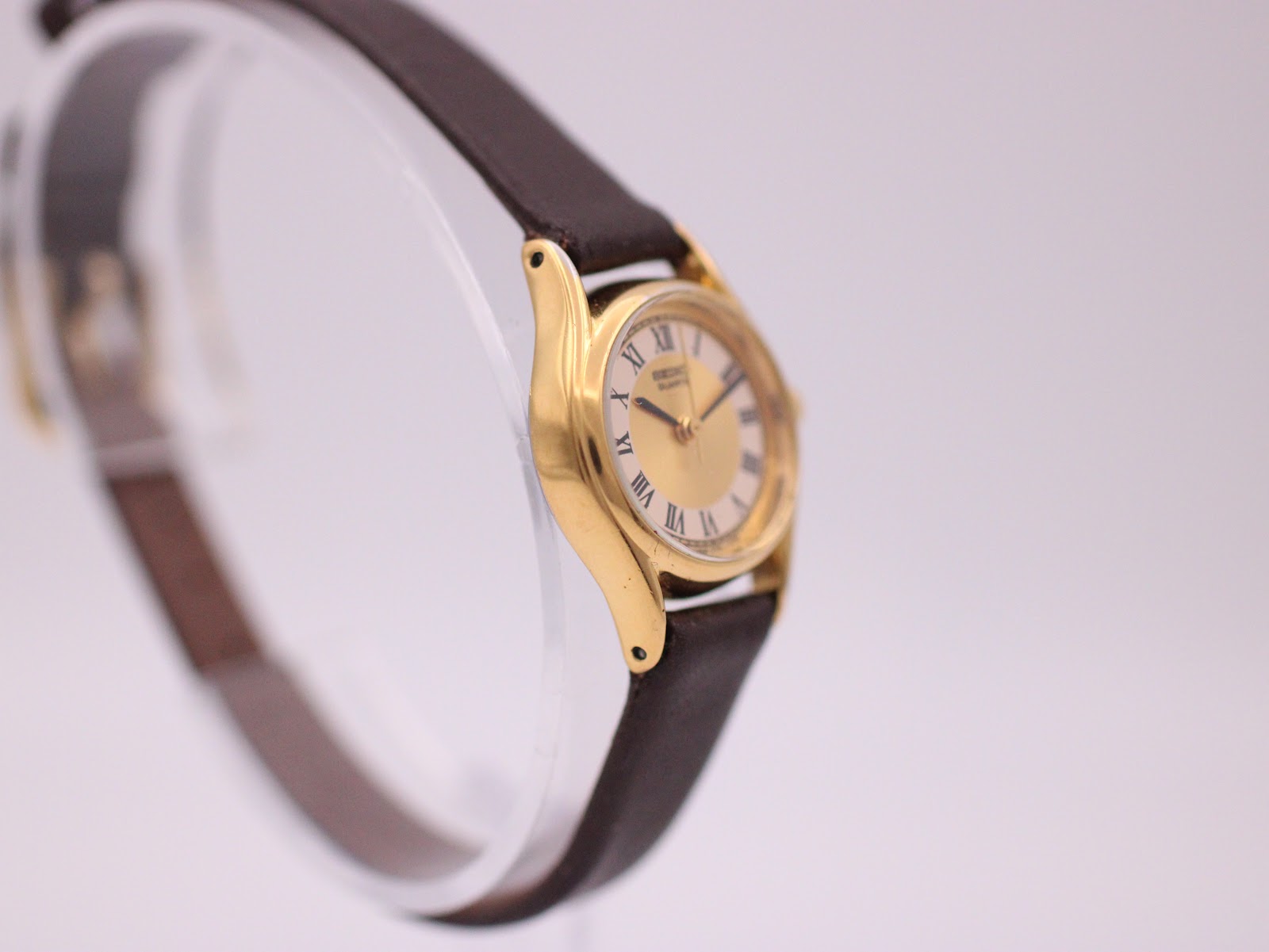 Left-side view of the Seiko watch, highlighting the slender case profile and integrated lugs.