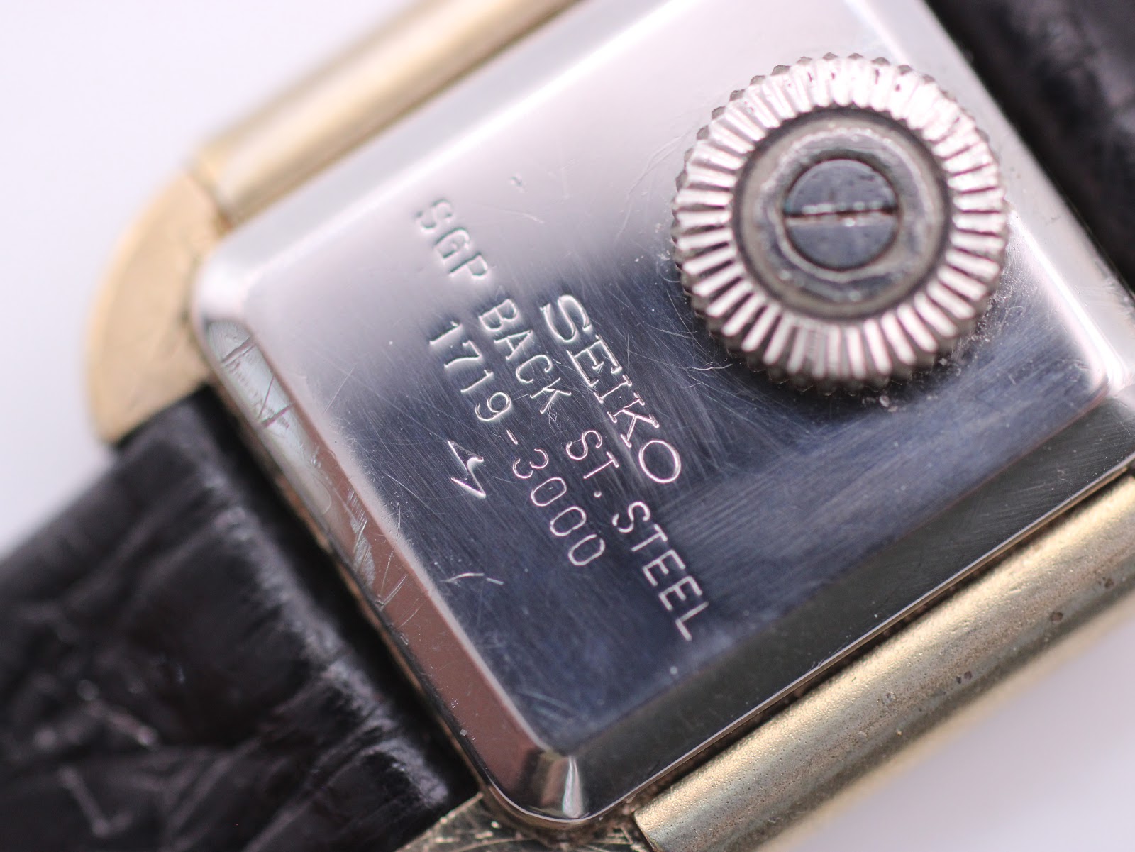Close-up of the watch case back, revealing "SEIKO SGP BACK ST. STEEL 1719-3000" engravings and the crown.