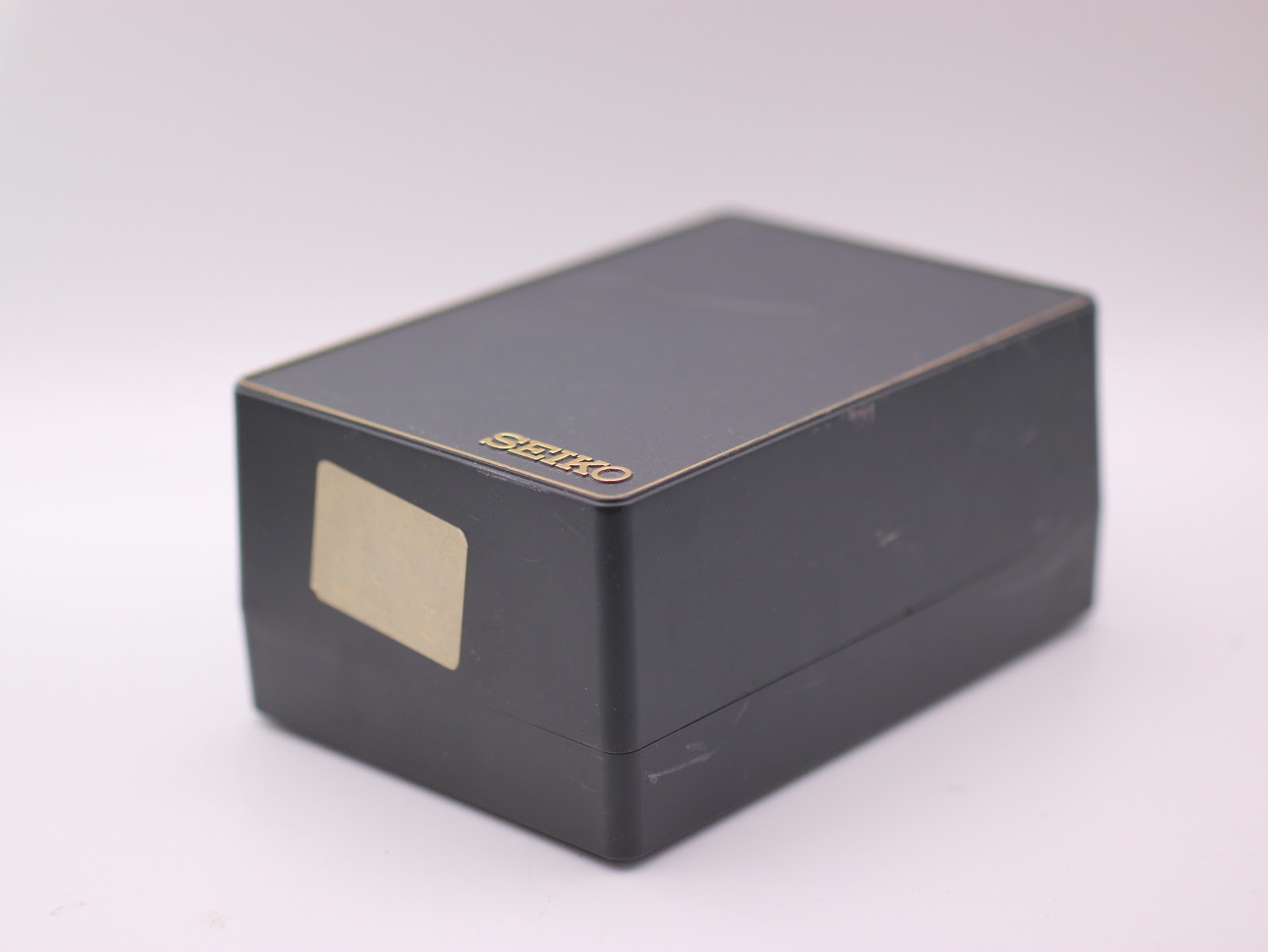 Closed view of the original black Seiko watch box with gold lettering.