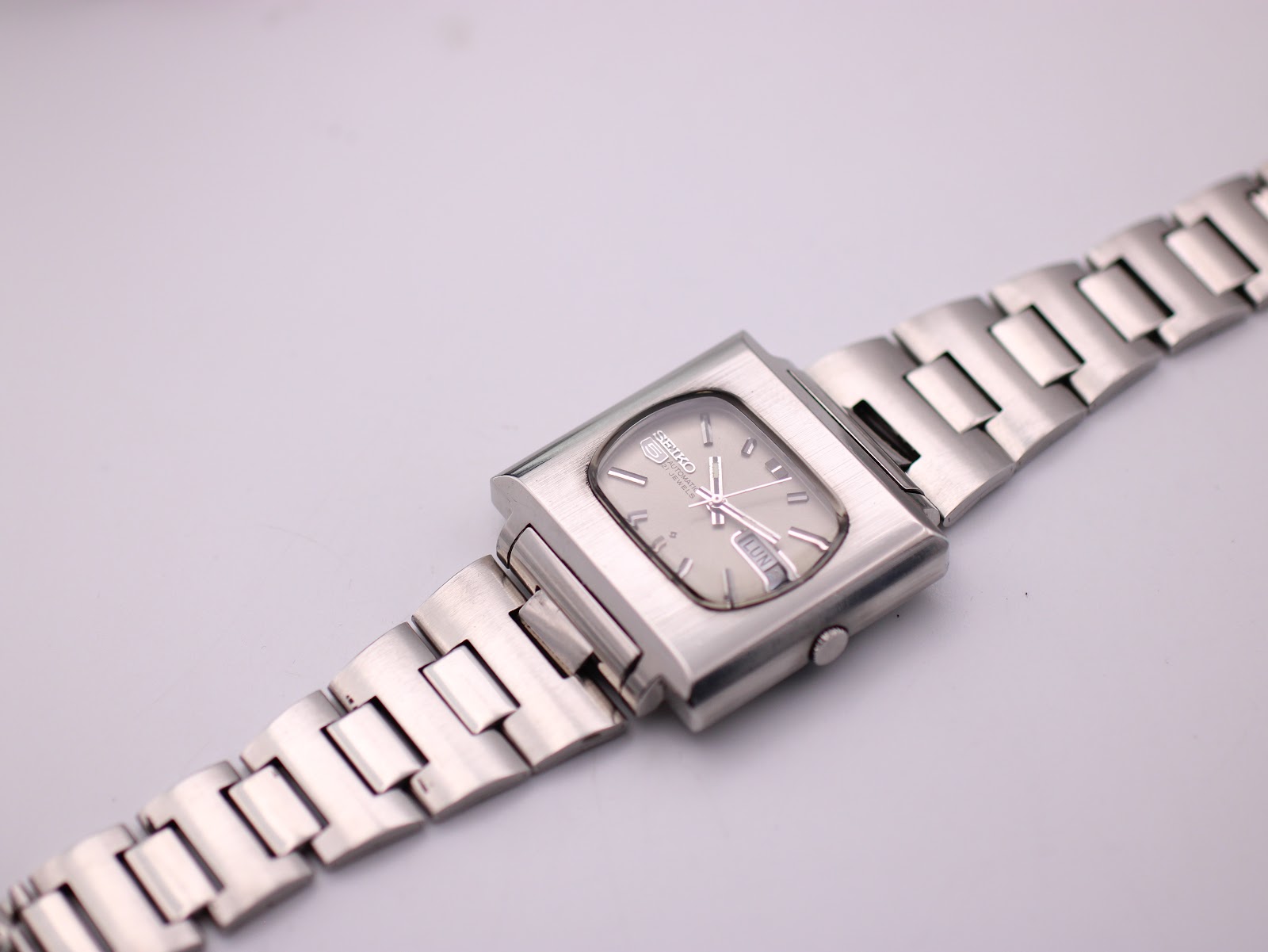 Overhead view of vintage Seiko 6119-5401 with flat integrated steel bracelet extended.