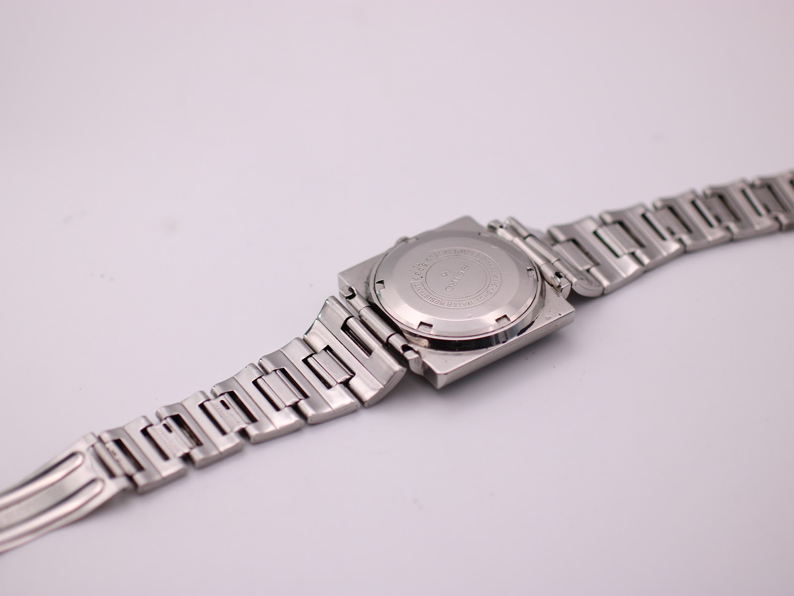 View of the case back of the Seiko 6119-5401 and the steel bracelet, showing model and serial number.