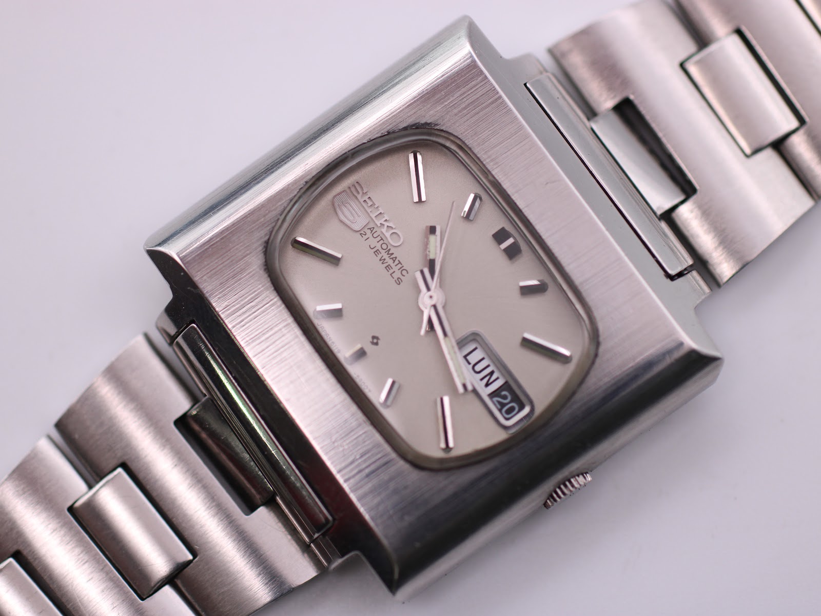 Close-up overhead view of the Seiko 6119-5401 dial, showing day-date window and baton indices.
