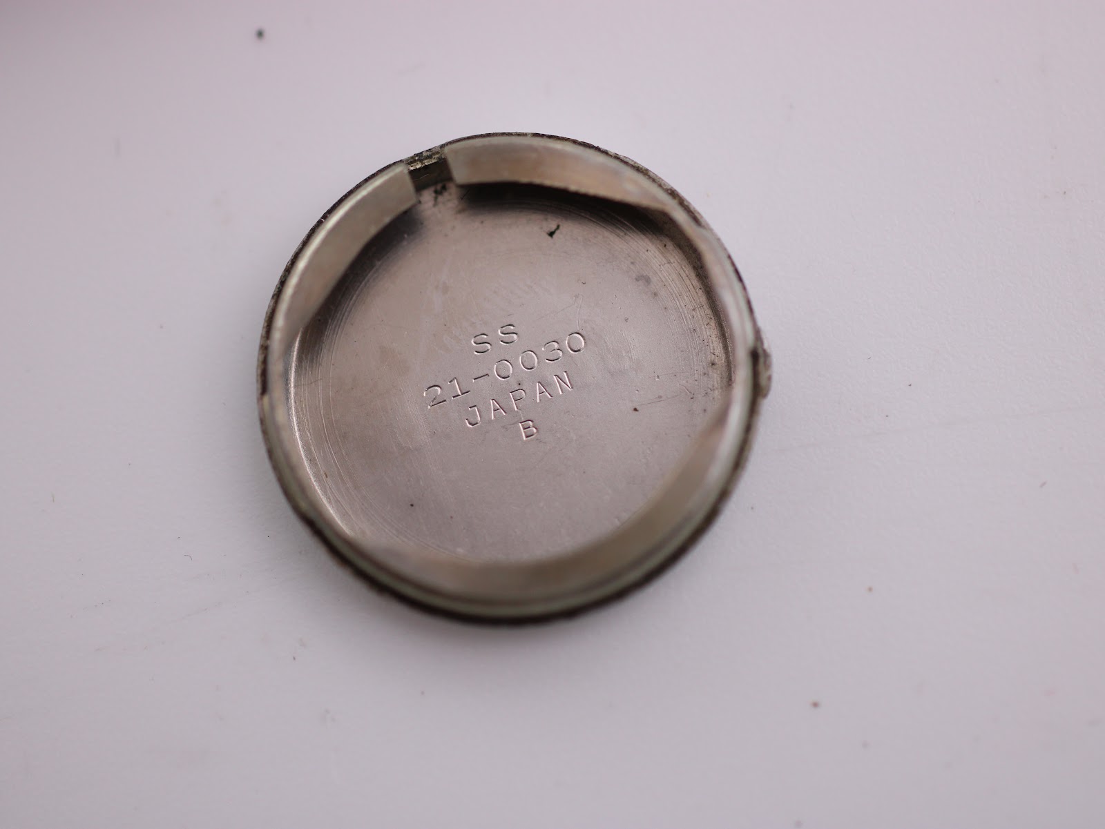 Inside of the case back, showing 'SS 21-0030 JAPAN B' markings.