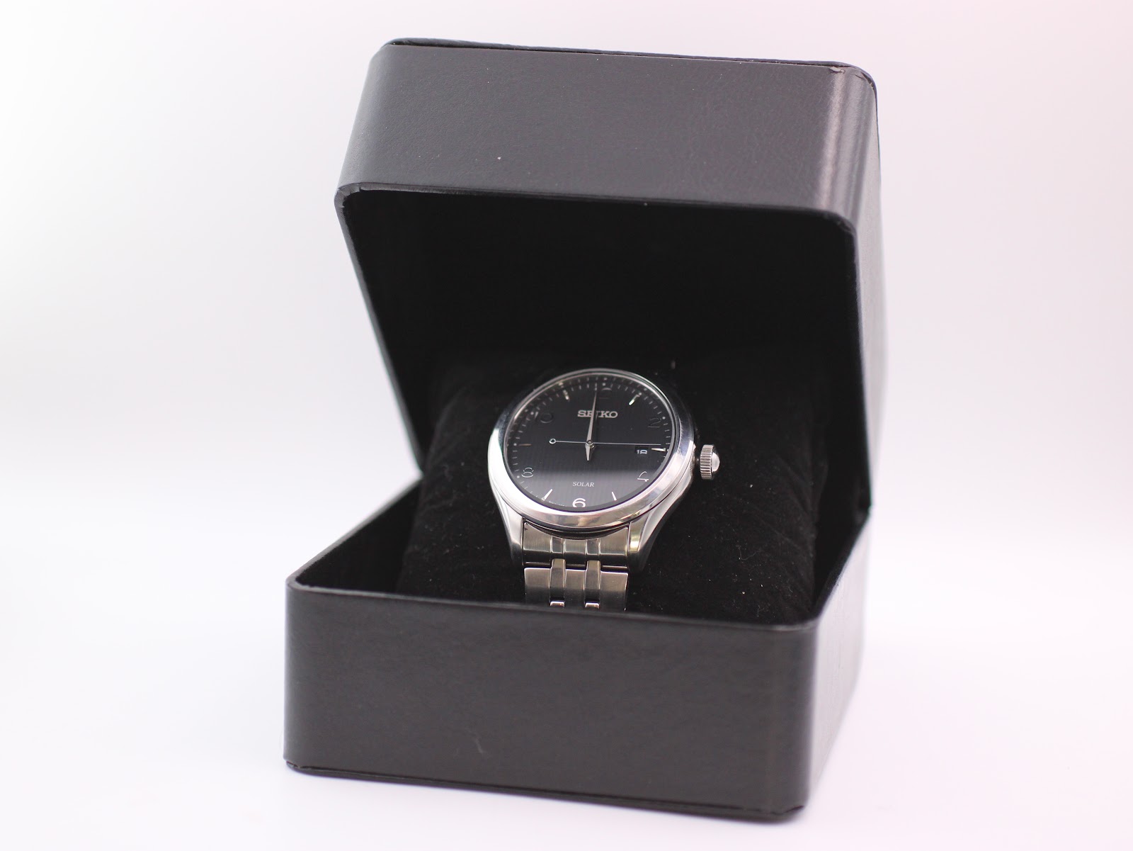 The Seiko V157-0CNO watch presented inside its original black Seiko box.
