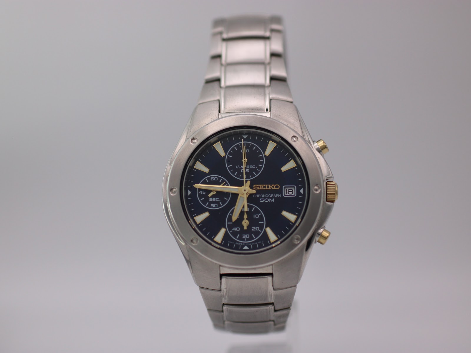 Front view of the Seiko 7T92-0FX0 chronograph in its original Seiko box, with accompanying papers.