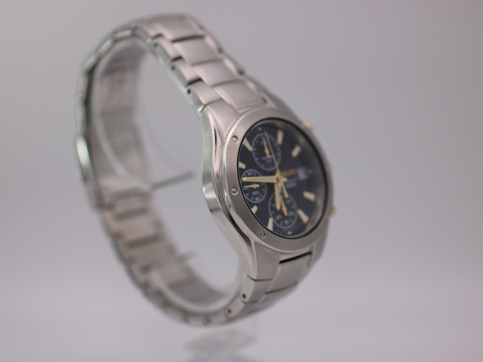 Another angled side view of the Seiko watch, showing the integrated stainless steel bracelet and case profile.