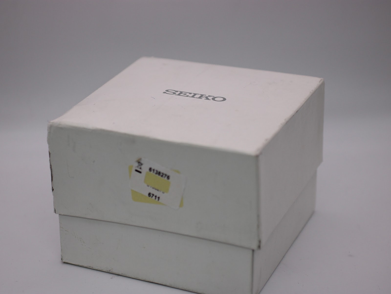 Angled view of the original white Seiko presentation box, showing a sticker on the side.