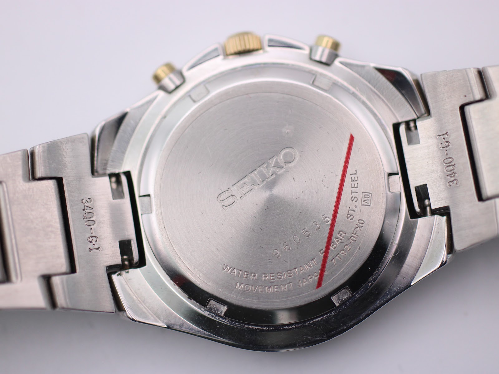 Rear view of the Seiko watch's case back, displaying the model number, serial number, and 'WATER RESISTANT 5 BAR' engraving.