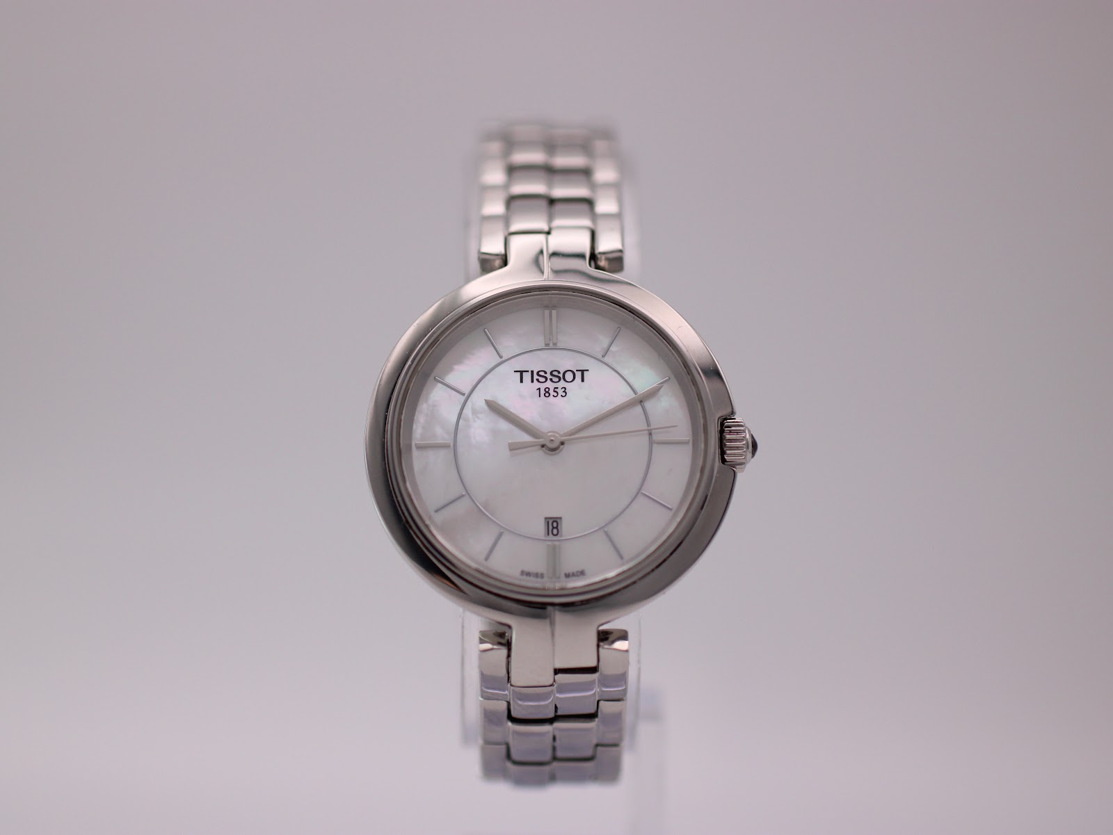 Front view of the Tissot T094210 A ladies' watch with a white mother-of-pearl dial and stainless steel bracelet.