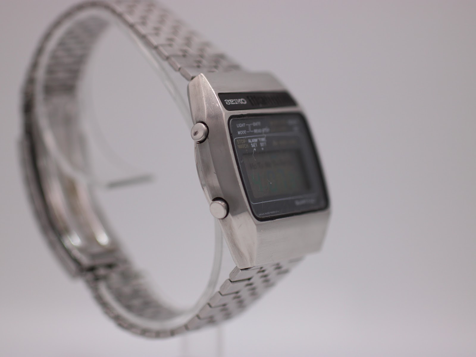 Angled side view of the Seiko A159-5009-G watch, showing the smooth case profile on the left side and bracelet links.