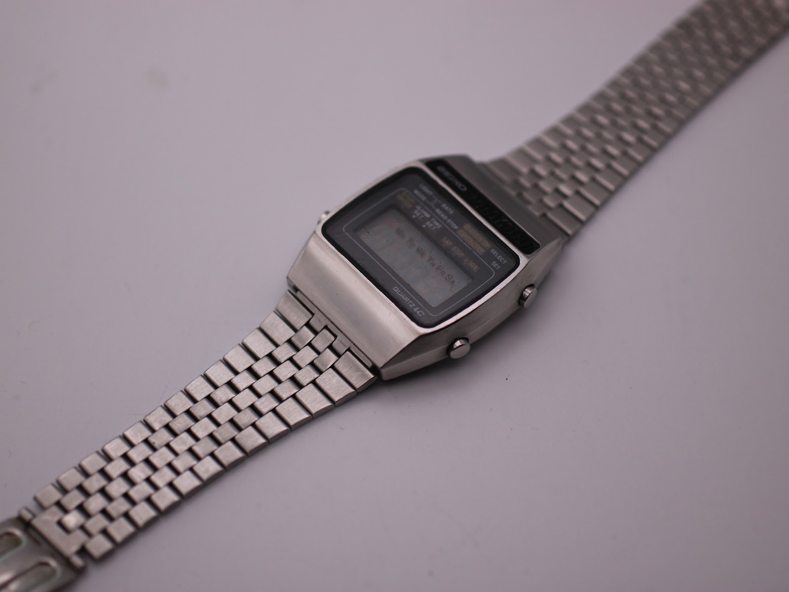 Top-down angled view of the Seiko A159-5009-G watch, displaying the rectangular case and full length of the integrated steel bracelet.