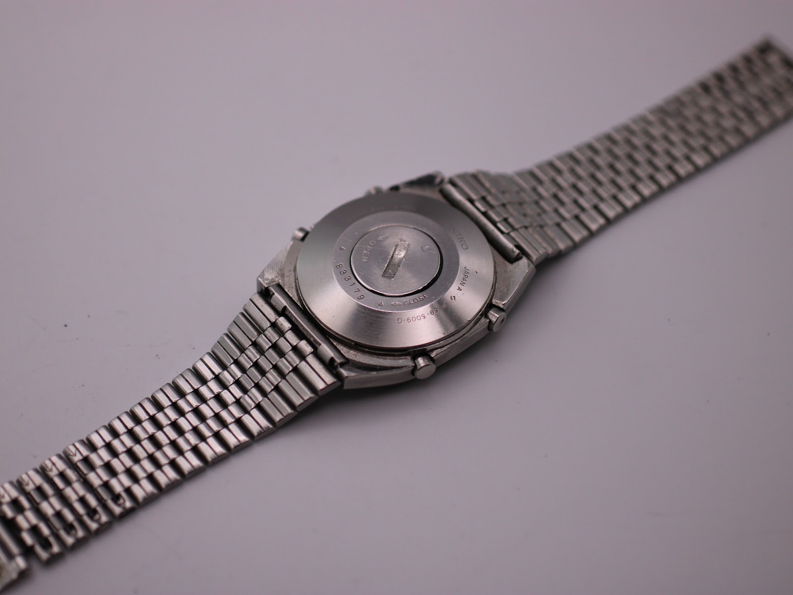 Rear view of the Seiko A159-5009-G watch, showing the stainless steel case back and the multi-link bracelet.