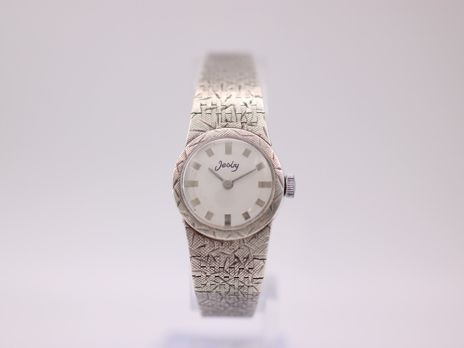 Angled front view of the Jesty sterling silver ladies' watch with cream dial and textured bracelet.