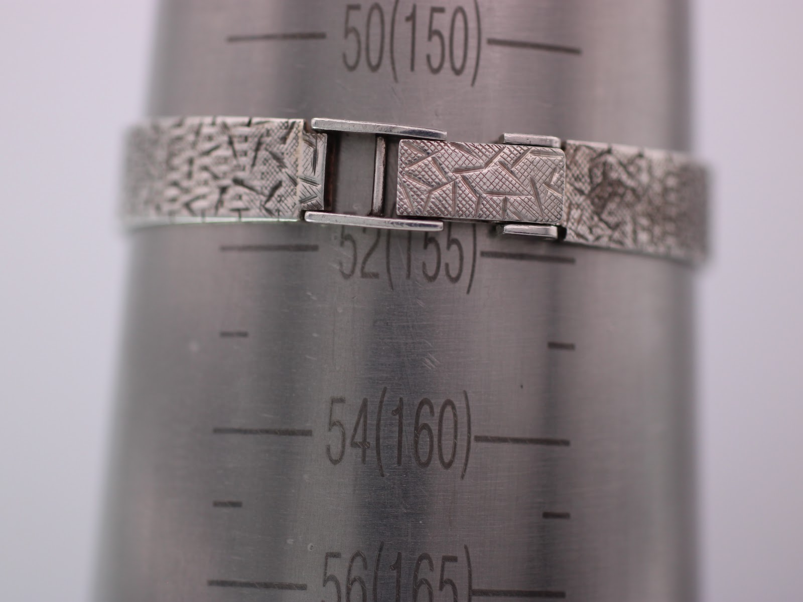 Jesty watch bracelet clasped around a wrist sizing gauge, indicating a wrist size of approximately 15cm.
