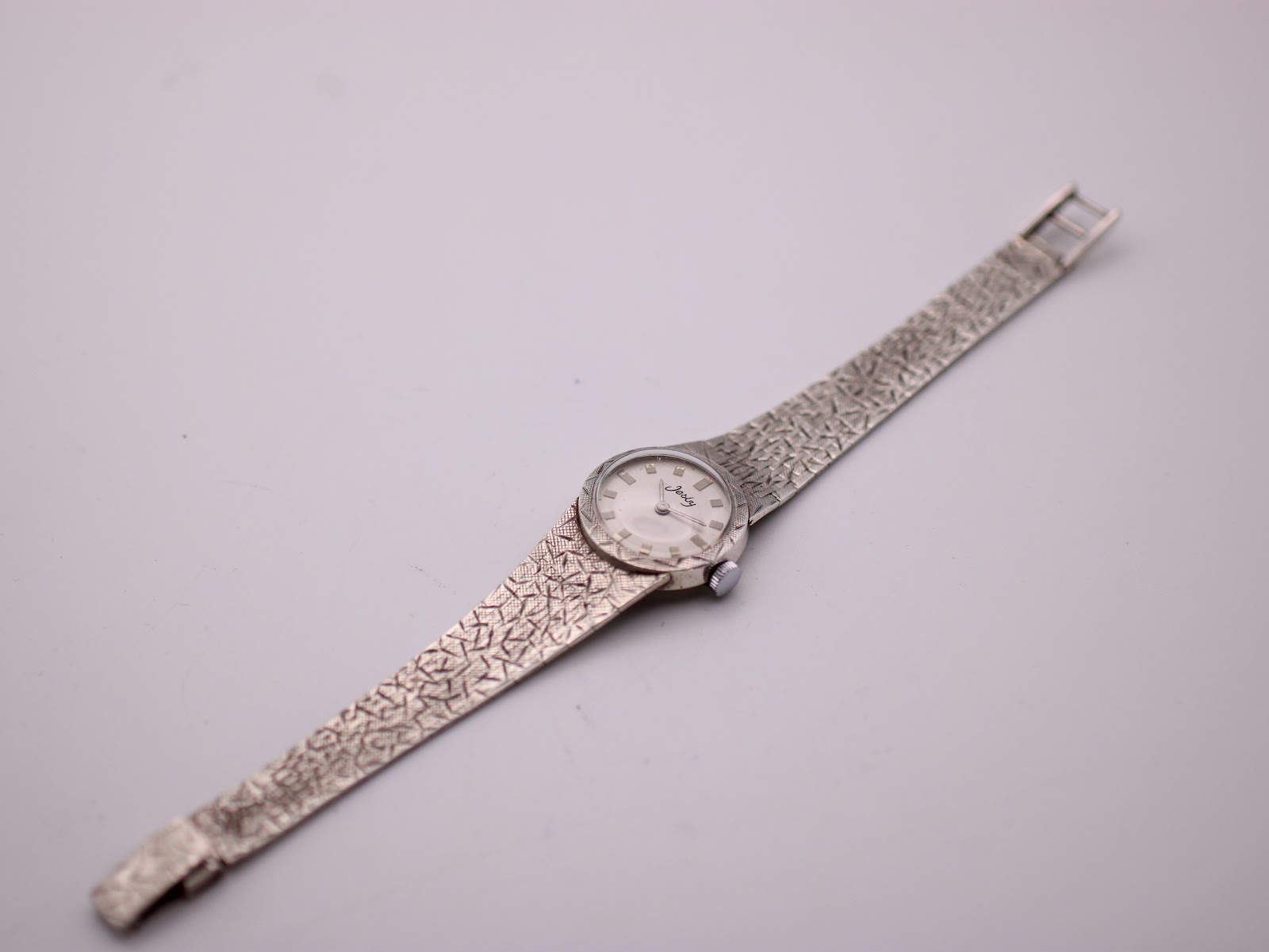 Overhead view of the Jesty watch, showing its full length and textured sterling silver bracelet.