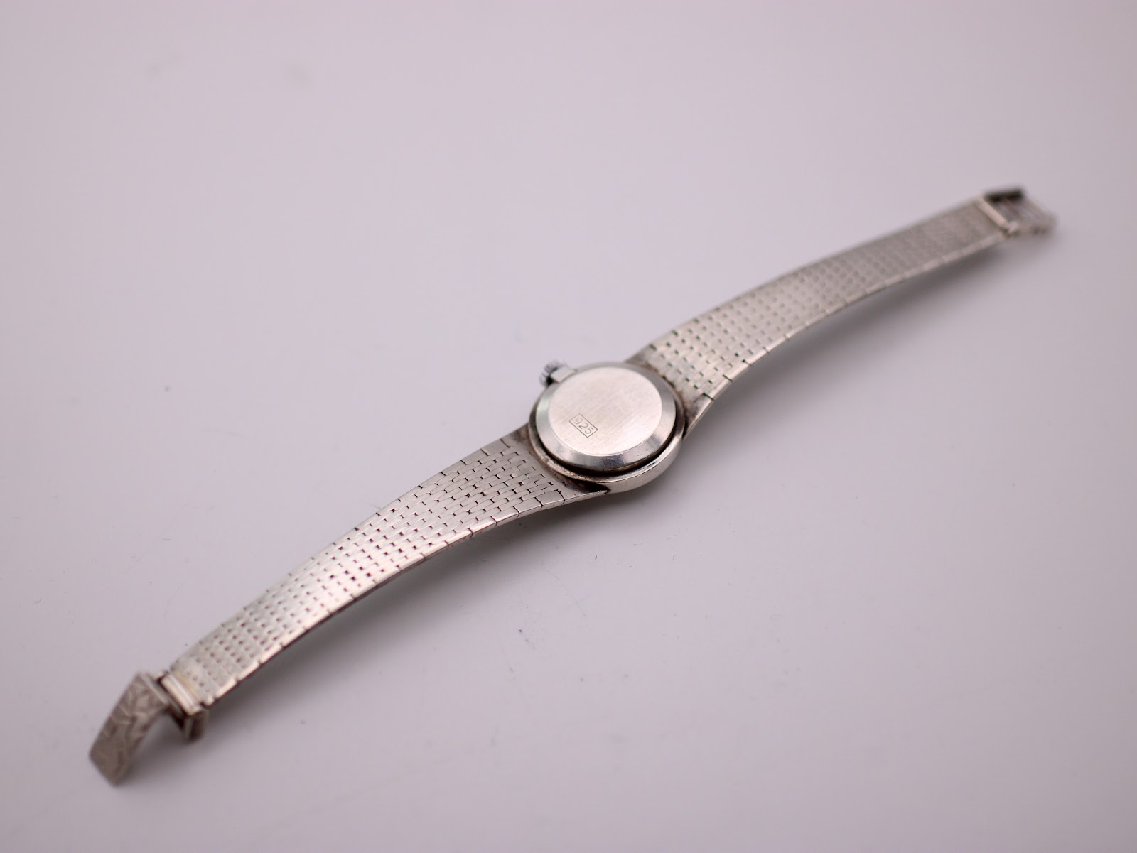 Underside view of the Jesty watch, revealing the smooth back of the bracelet and case.