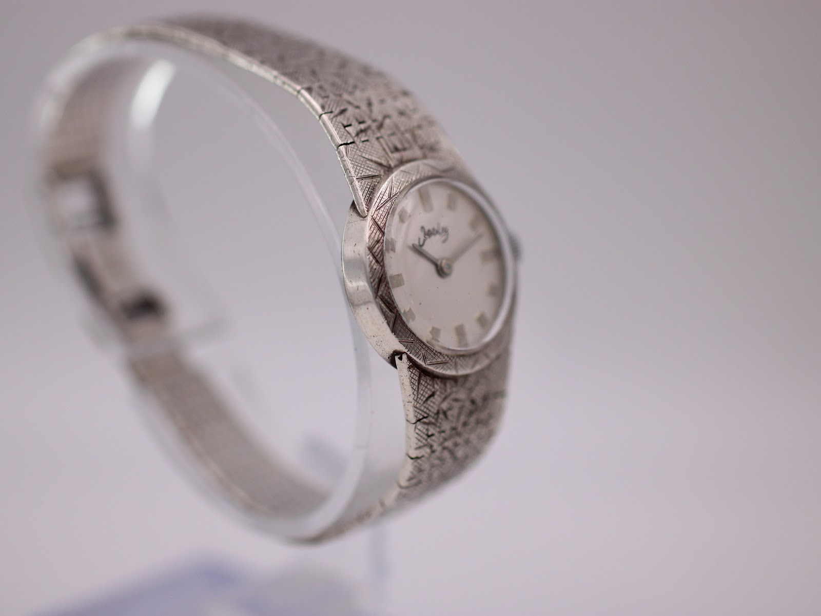 Three-quarter view of the Jesty watch on a display stand, highlighting the dial and decorative bezel.