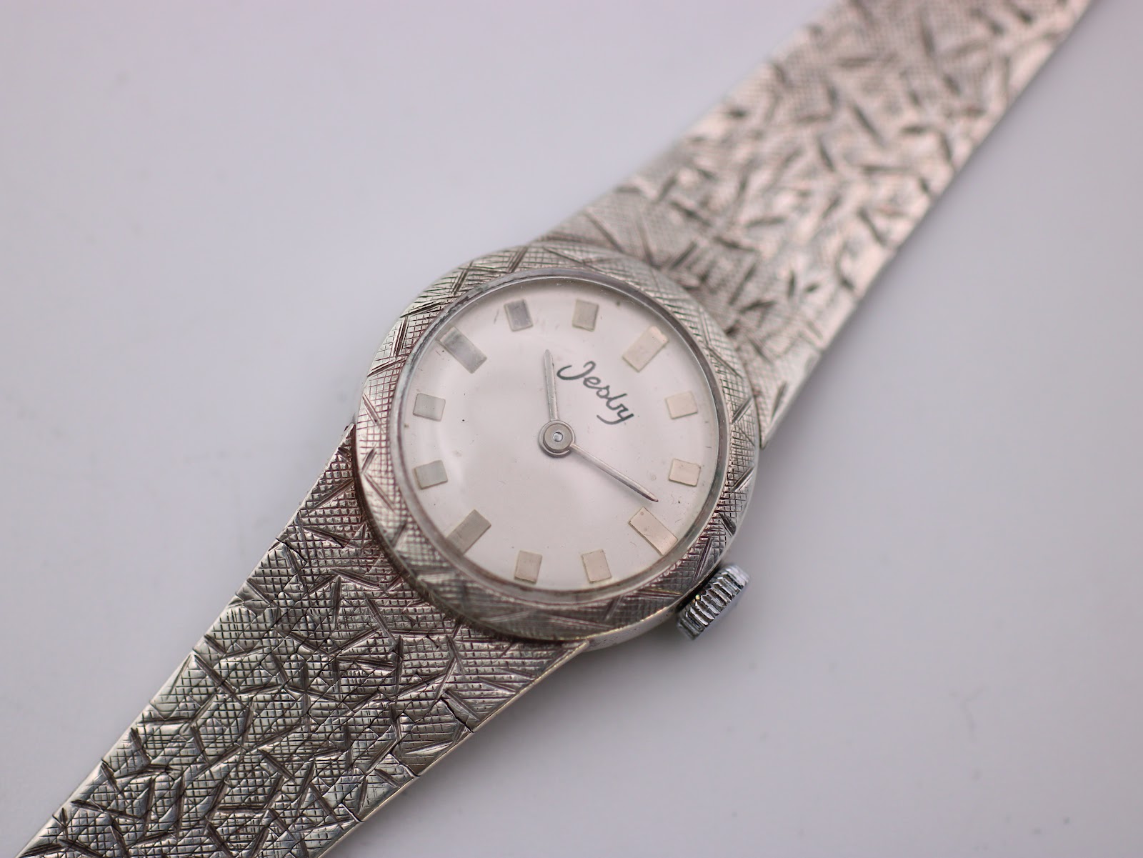 Close-up, top-down view of the Jesty watch dial and textured sterling silver bracelet.