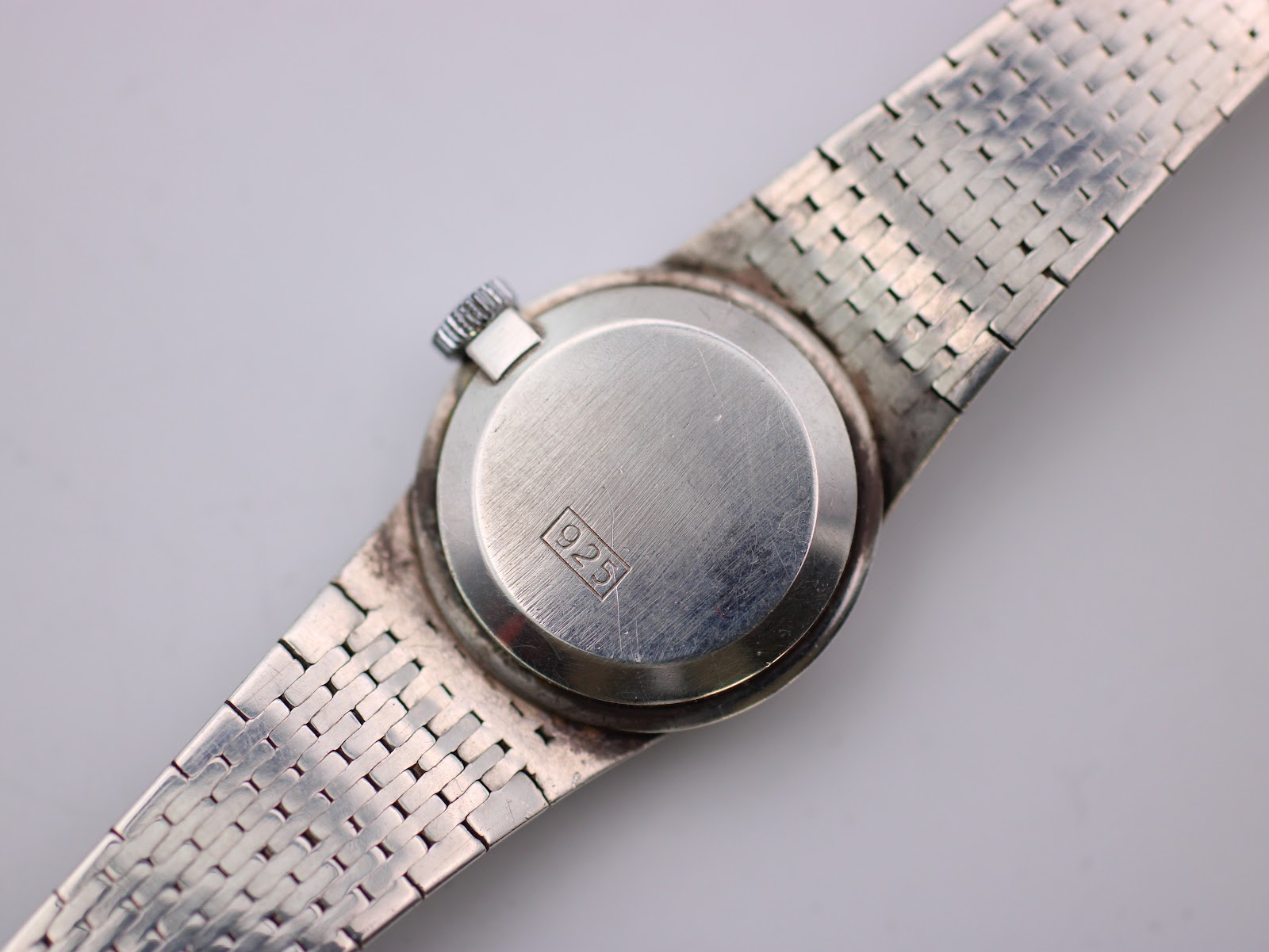 Rear view of the watch case back, showing the polished finish and a '925' sterling silver hallmark.
