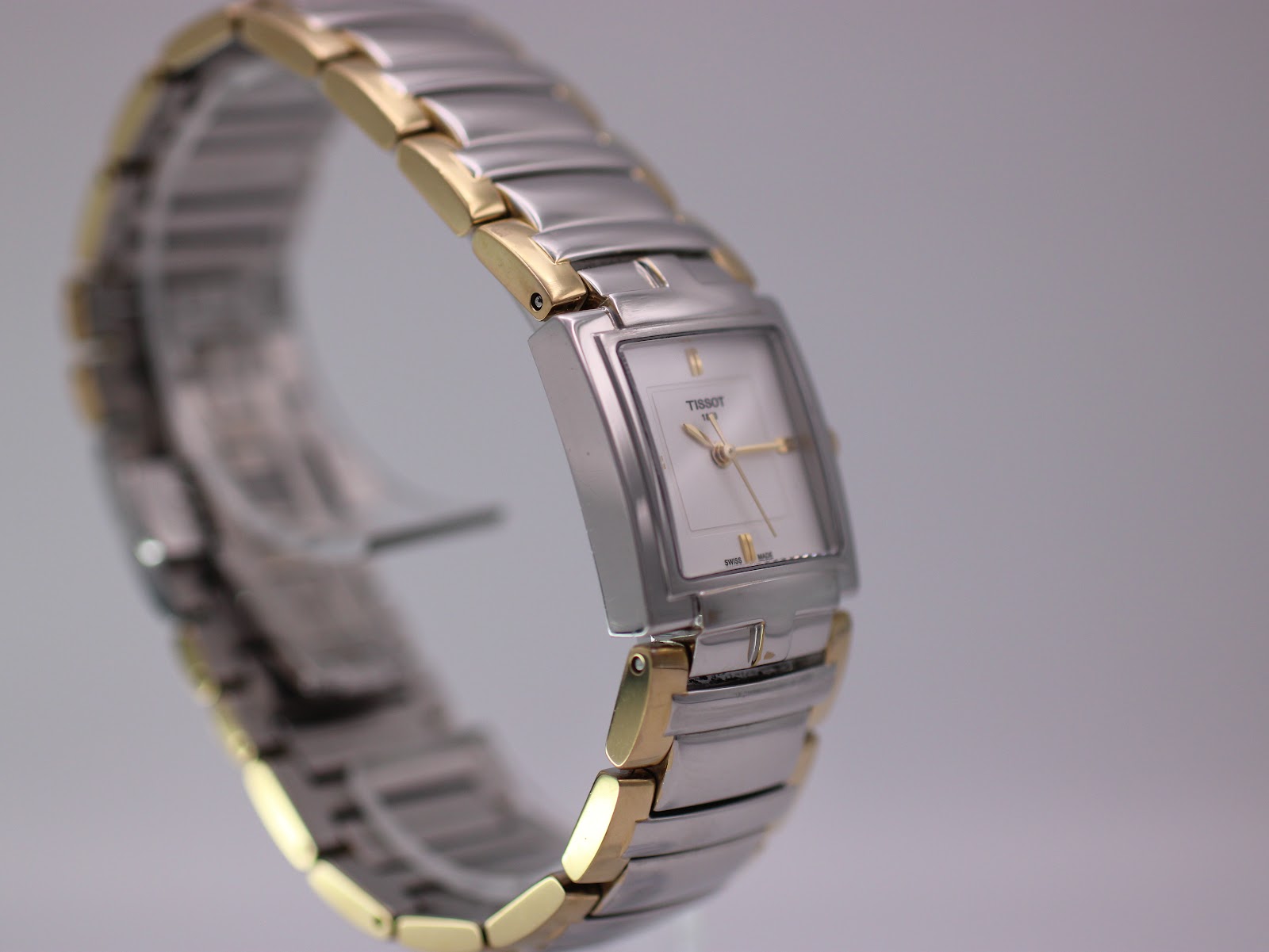 Another angled view of the Tissot watch, highlighting the integrated two-tone bracelet design from a different perspective.