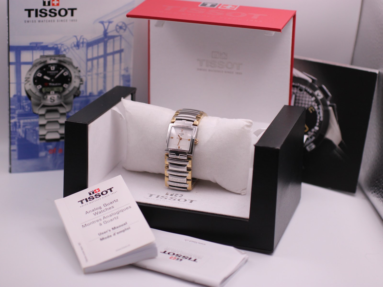 The Tissot T051310 A watch displayed within its original Tissot box, accompanied by its user manual and papers.