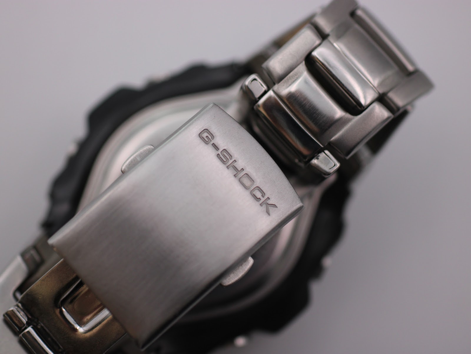 Close-up of the G-Shock G-510D's stainless steel deployant clasp, signed with 'G-SHOCK'.