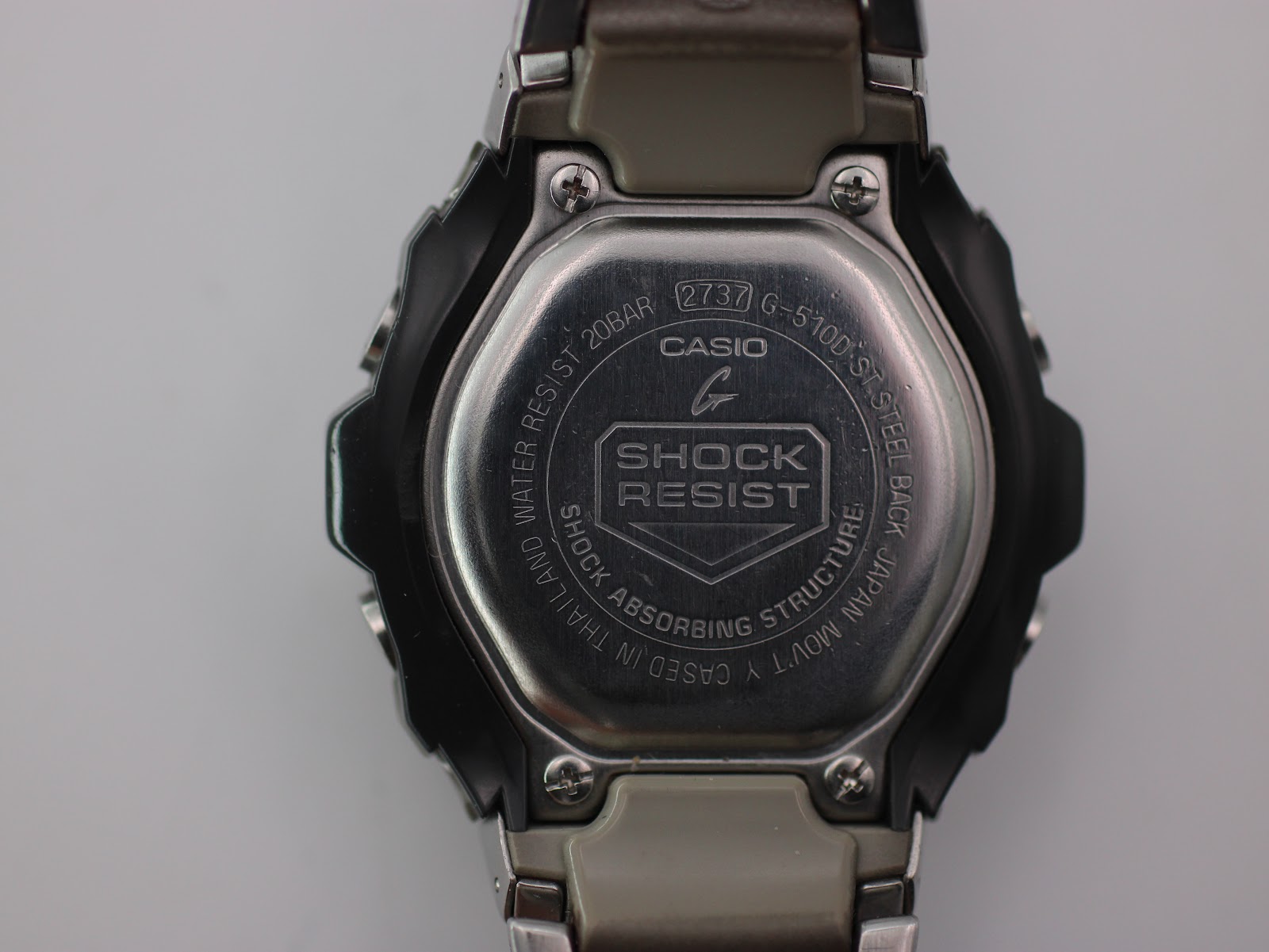 Case back of the Casio G-Shock G-510D, showing 'SHOCK RESIST', 'WATER RESIST 20BAR', 'G-510D', and movement details.