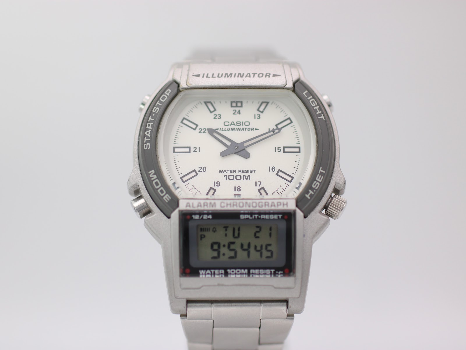 Front view of Casio AW-61 ana-digi watch with white dial, digital display, and silver steel bracelet.