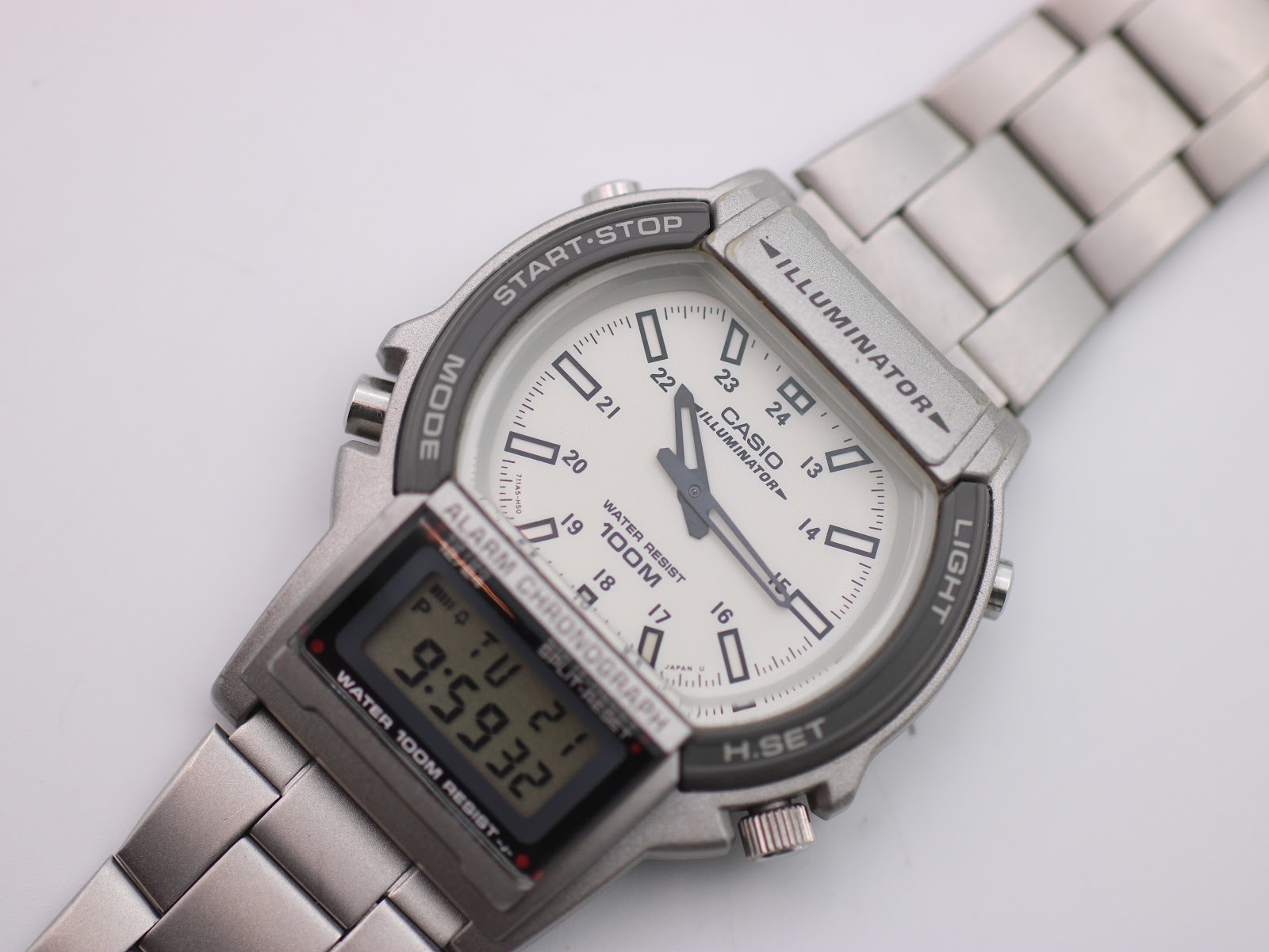 Angled close-up of Casio AW-61 dial and digital display, highlighting 'Illuminator' text and dial markings.