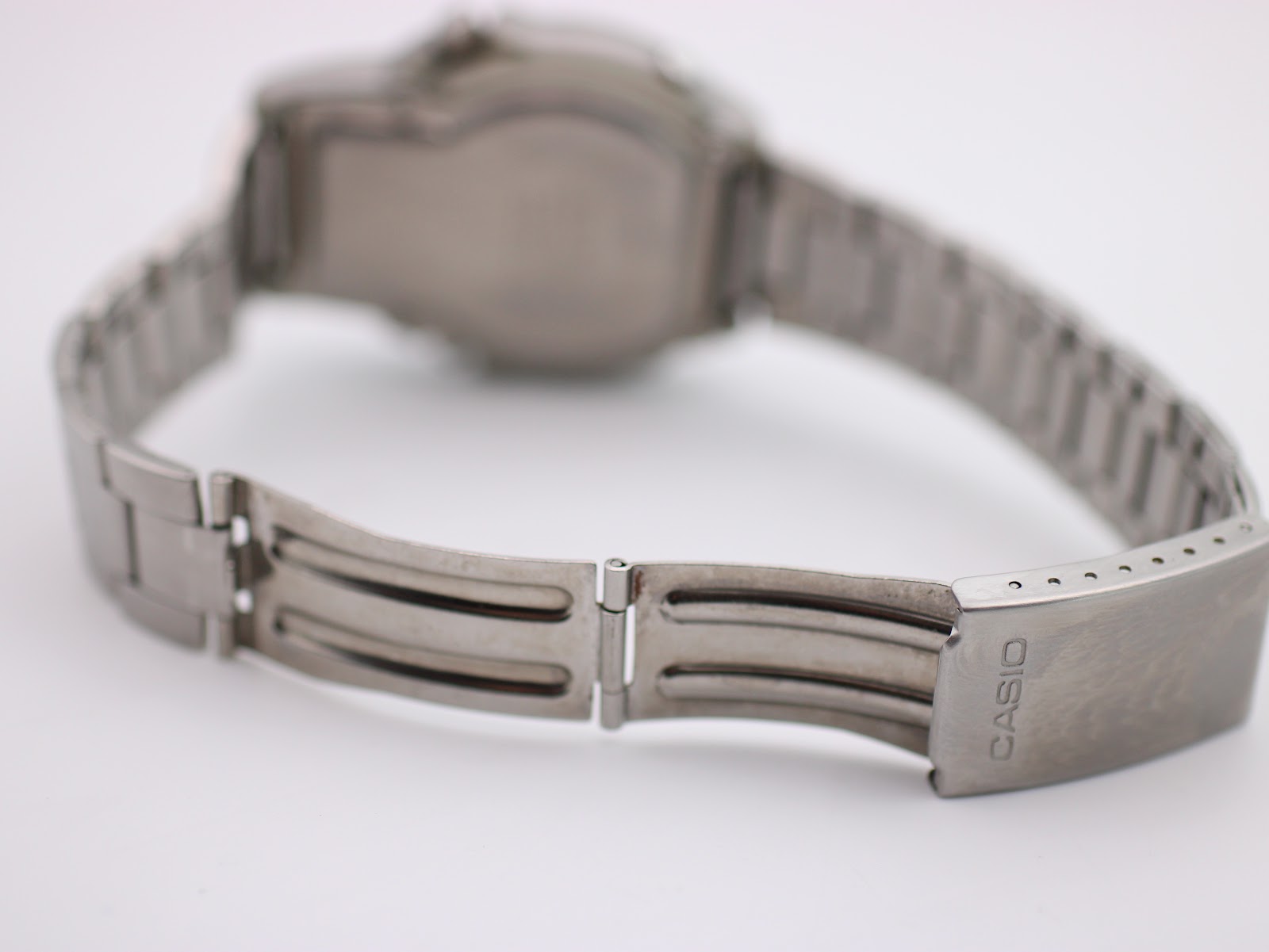 Rear view of the Casio AW-61 steel bracelet with a signed fold-over clasp, showing its construction.