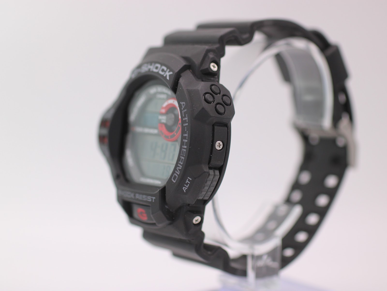 Right-side view of the Casio G-Shock GDF-100 watch on a stand, showing the mode buttons and black resin strap.