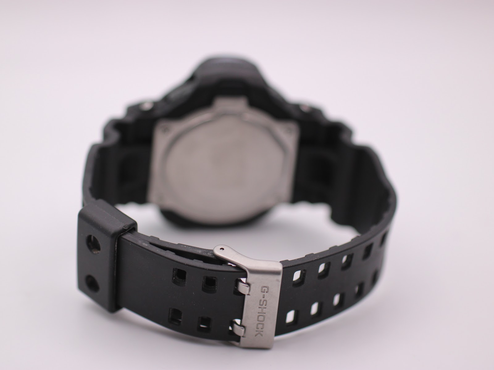 View of the Casio G-Shock GDF-100's black rubber strap and signed stainless steel buckle from the rear.