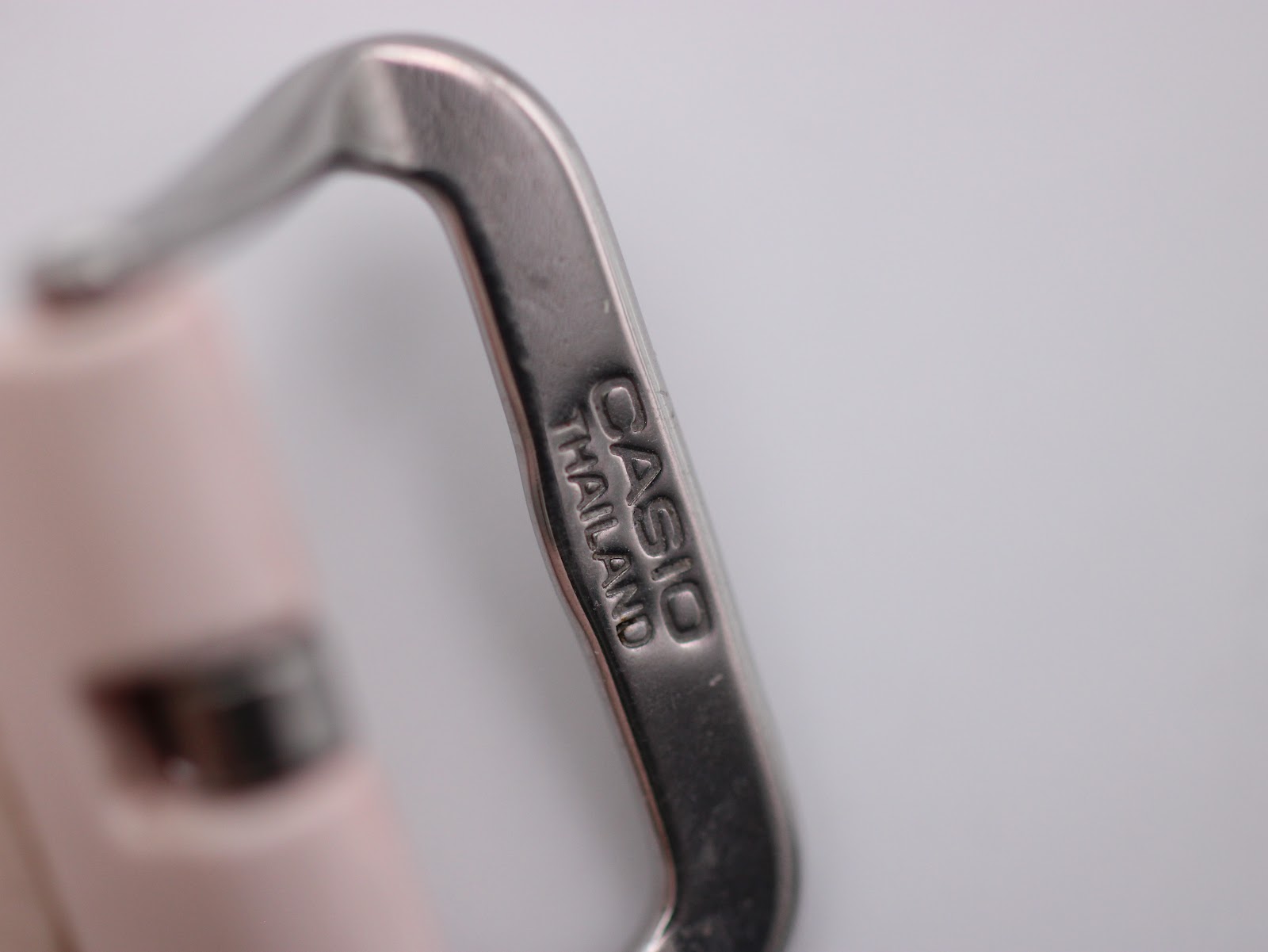 Macro close-up of the steel buckle, showing "CASIO THAILAND" engraving.