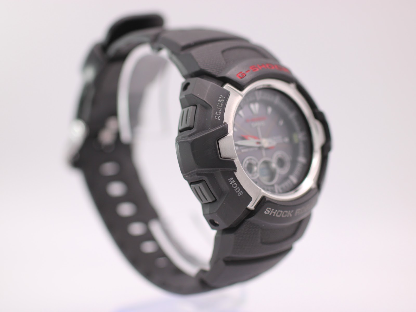 Angled side view of the G-Shock GW-1500A showing the left side of the black resin case with 'adjust' and 'mode' buttons.