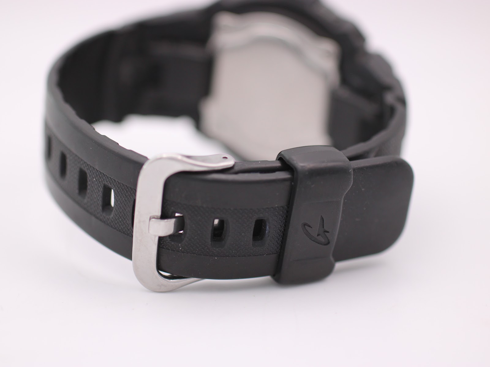 Close-up view of the black rubber strap and stainless steel buckle of the Casio G-Shock.