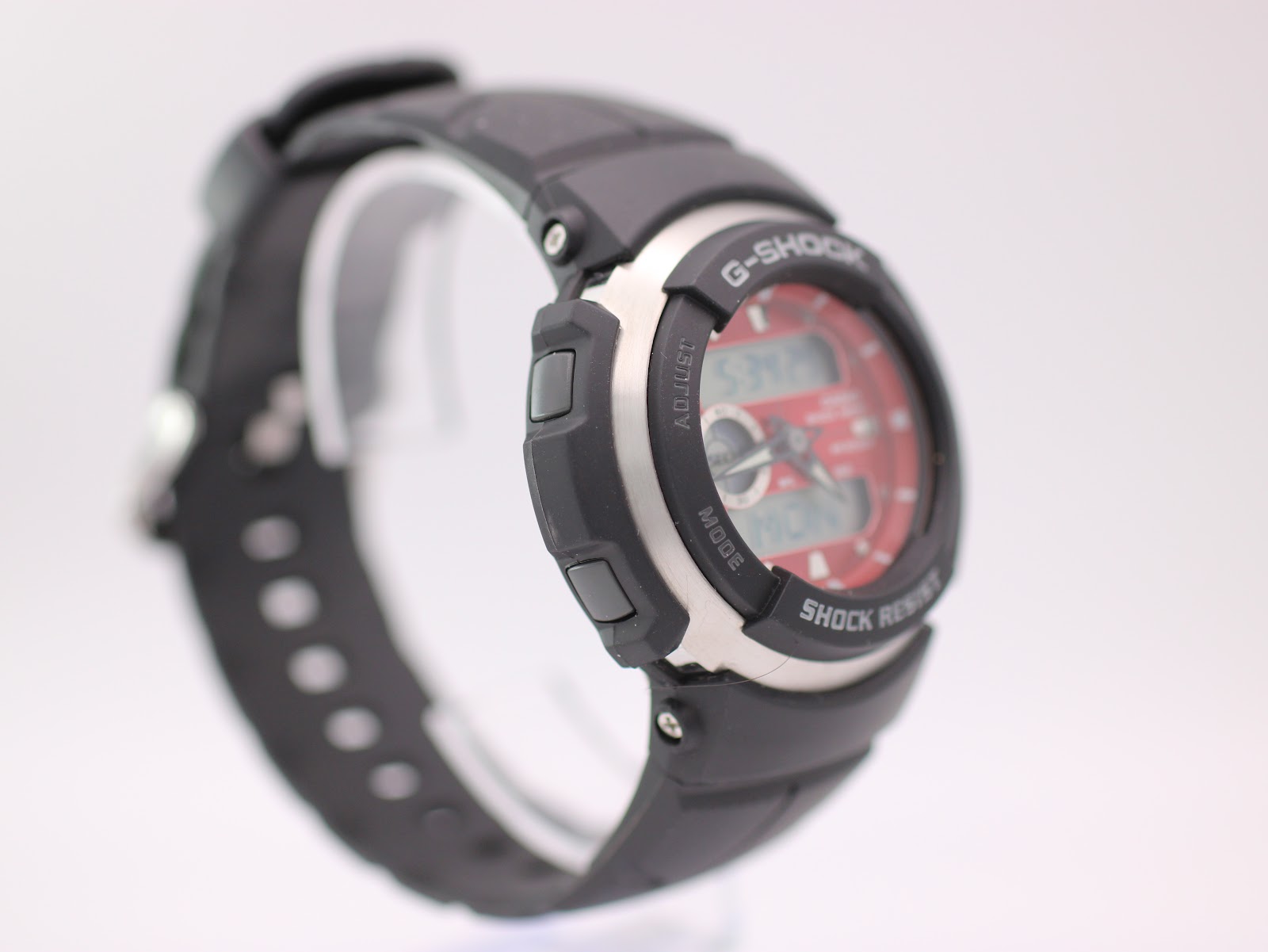 Left-side angled view of Casio G-Shock G-300 watch, showing the black resin case, stainless steel bezel, and control buttons.