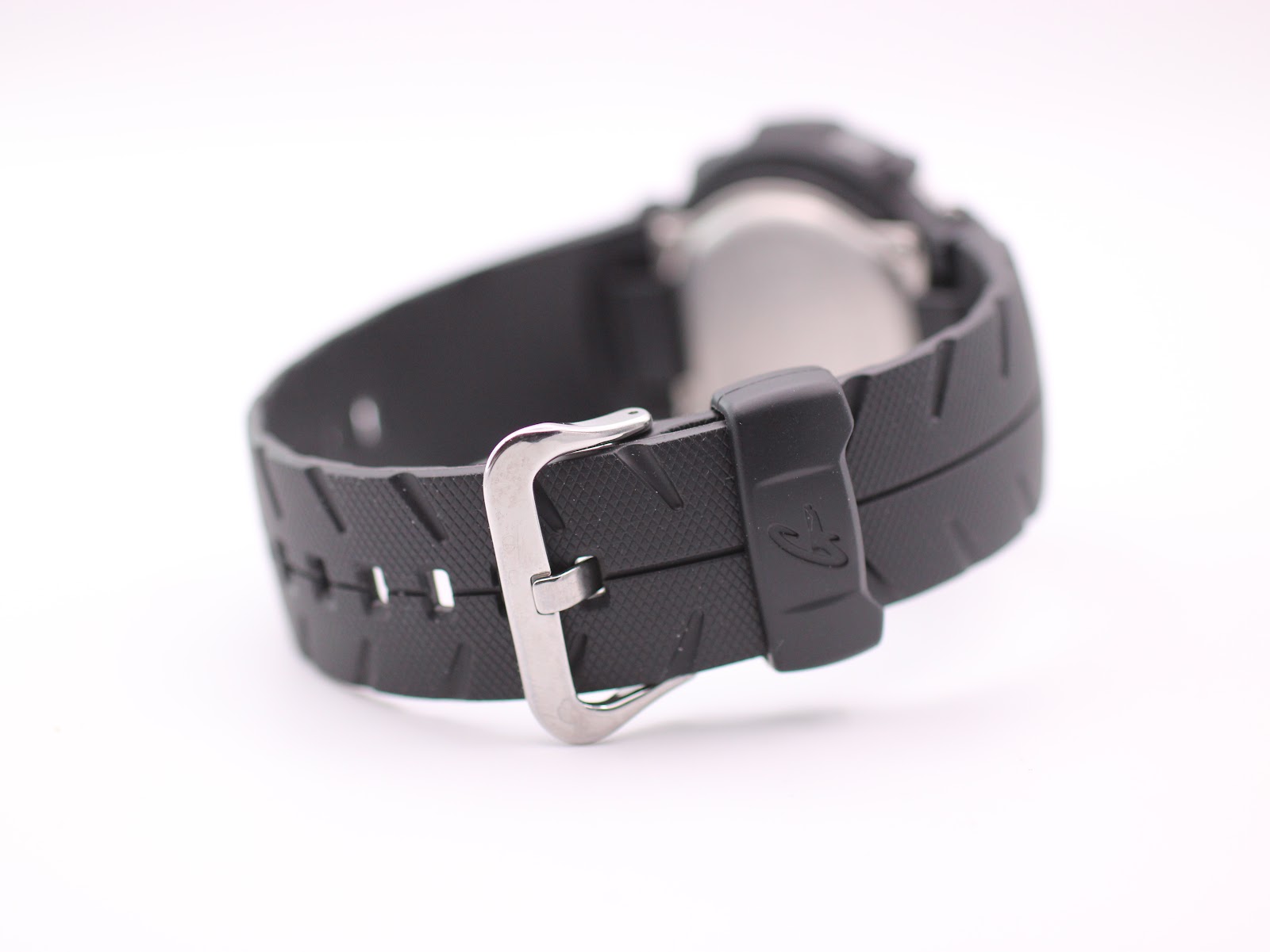 Close-up rear view of the black rubber strap and steel buckle on the Casio G-Shock G-300 watch.