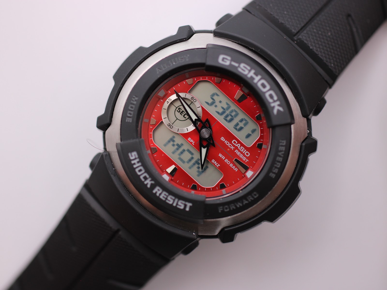 Close-up angled view of the red ana-digi dial of the Casio G-Shock G-300, showing current time and sub-dial.
