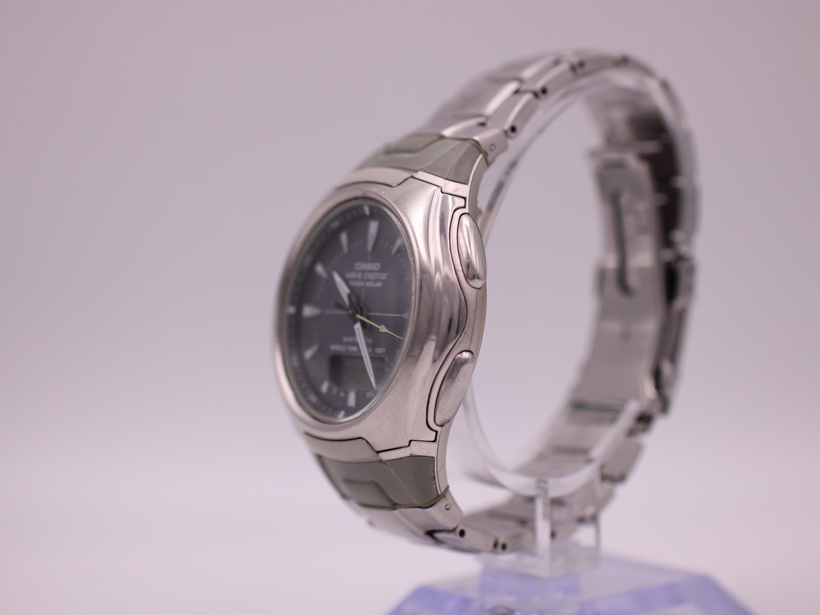 Left side view of the Casio Wave Ceptor watch on a display stand, showing the case profile.