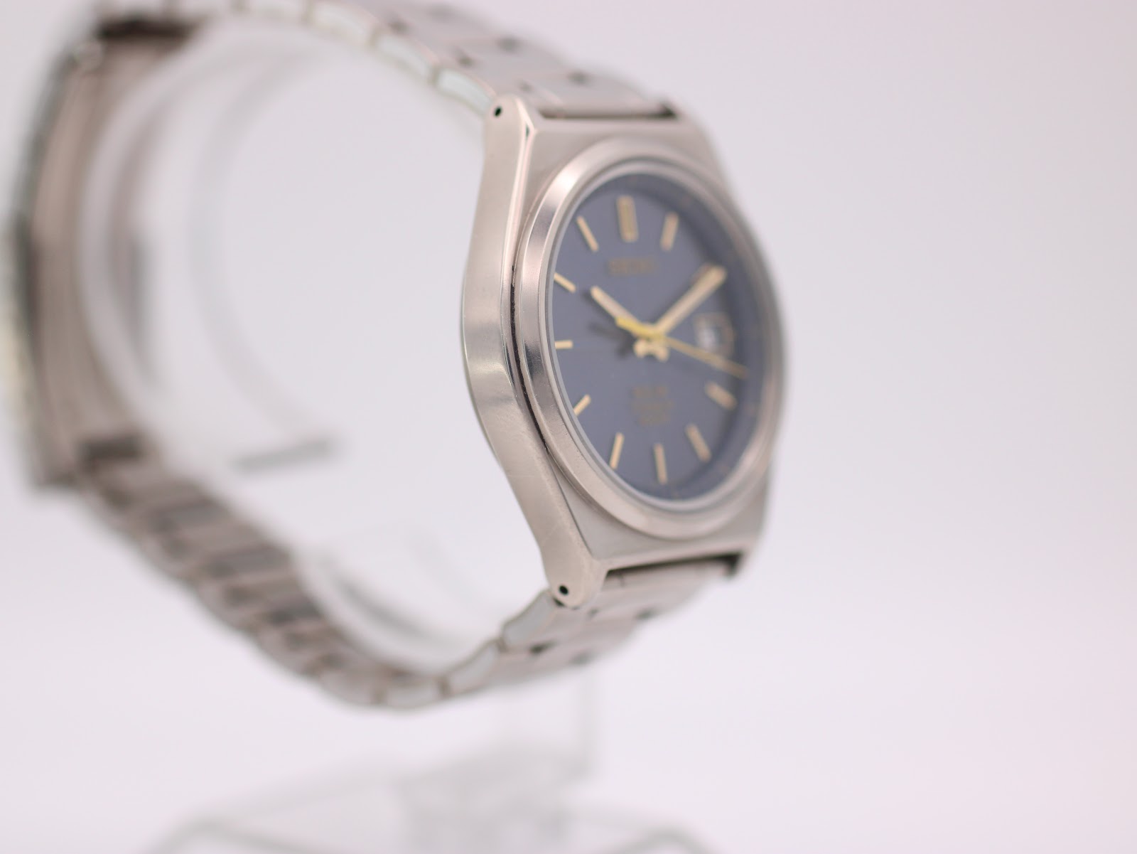 Left-side profile view of the Seiko titanium watch, highlighting the integrated bracelet design.