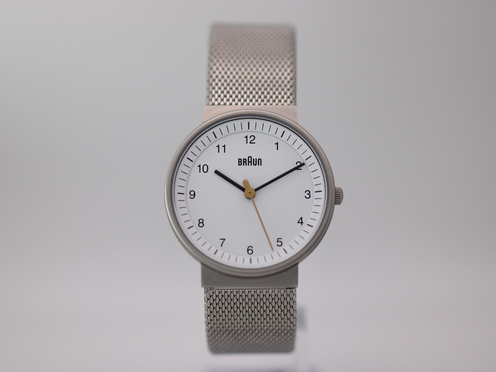 Front view of the Braun BN0031WHSLMHL watch in its original black box, accompanied by the user manual and hang tag.