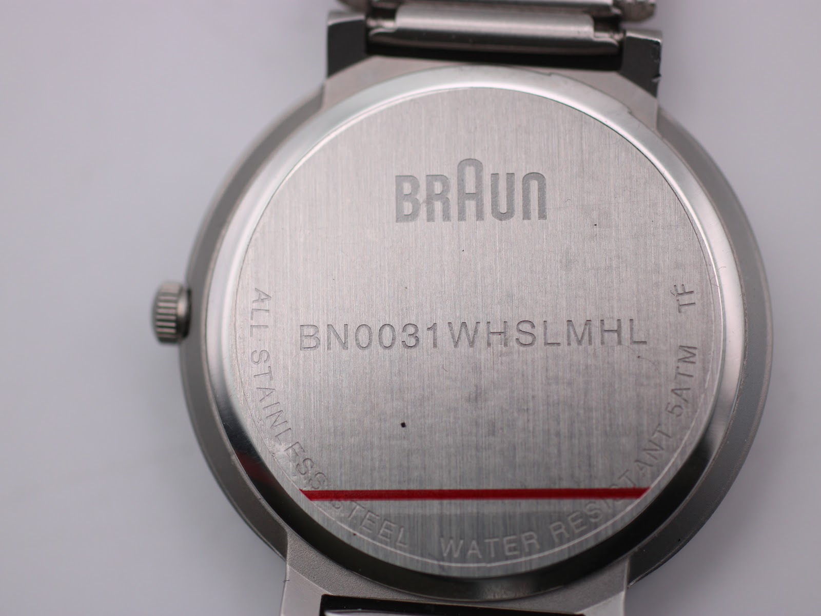 Close-up of the watch's case back, clearly engraved with "Braun", model number "BN0031WHSLMHL", "All stainless steel", and "Water resistant 5ATM".