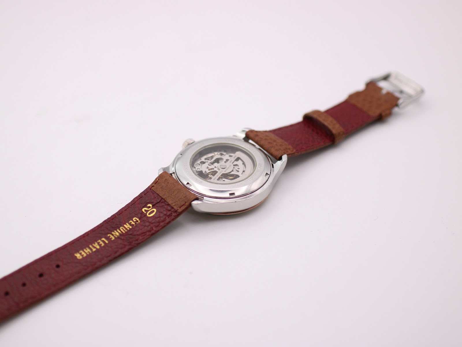 Back view of the watch, showing the case back and extended genuine leather strap with "20" lug width marking.