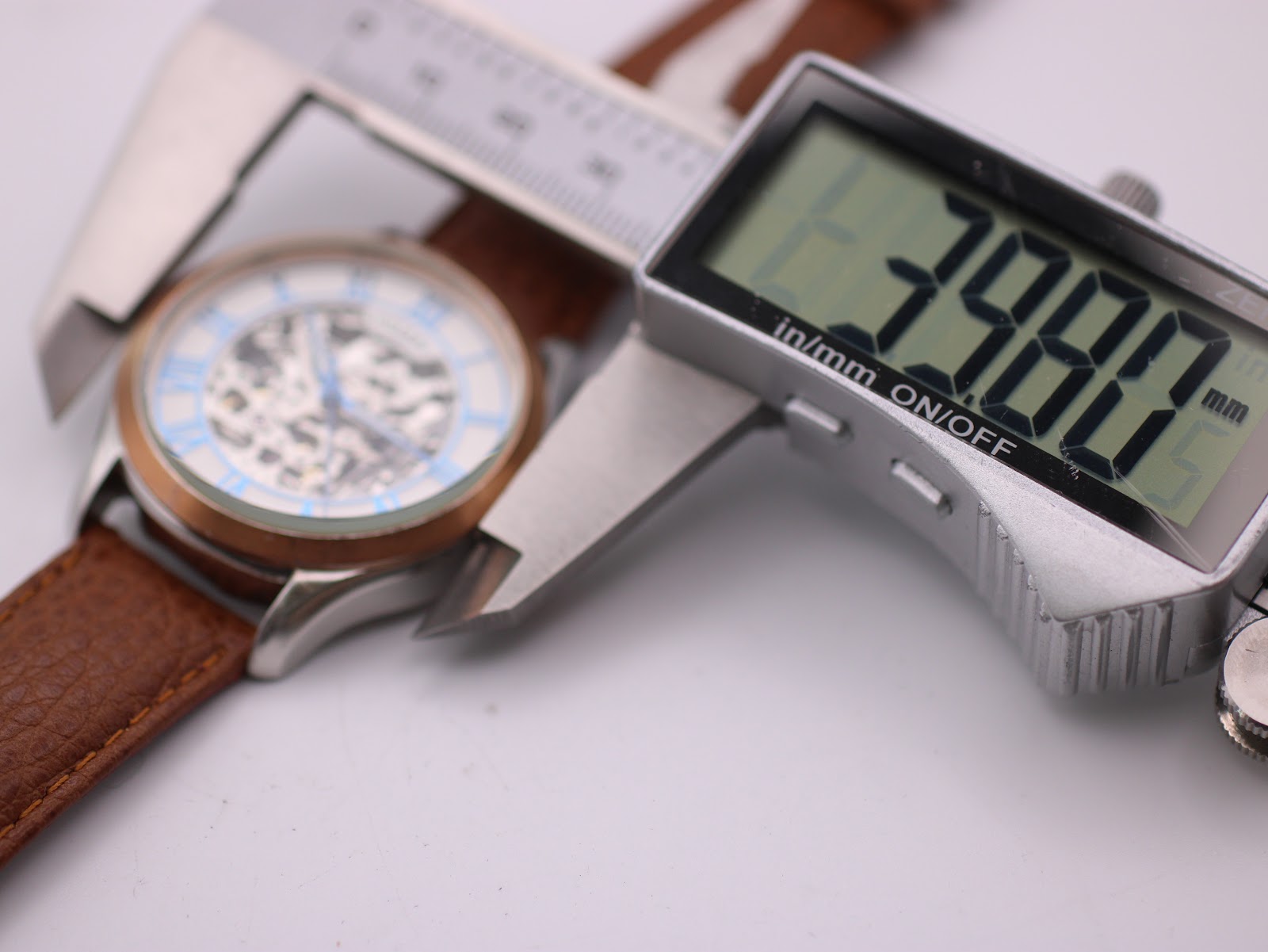 Digital caliper measuring the case diameter of the Rotary watch at 39.88mm.