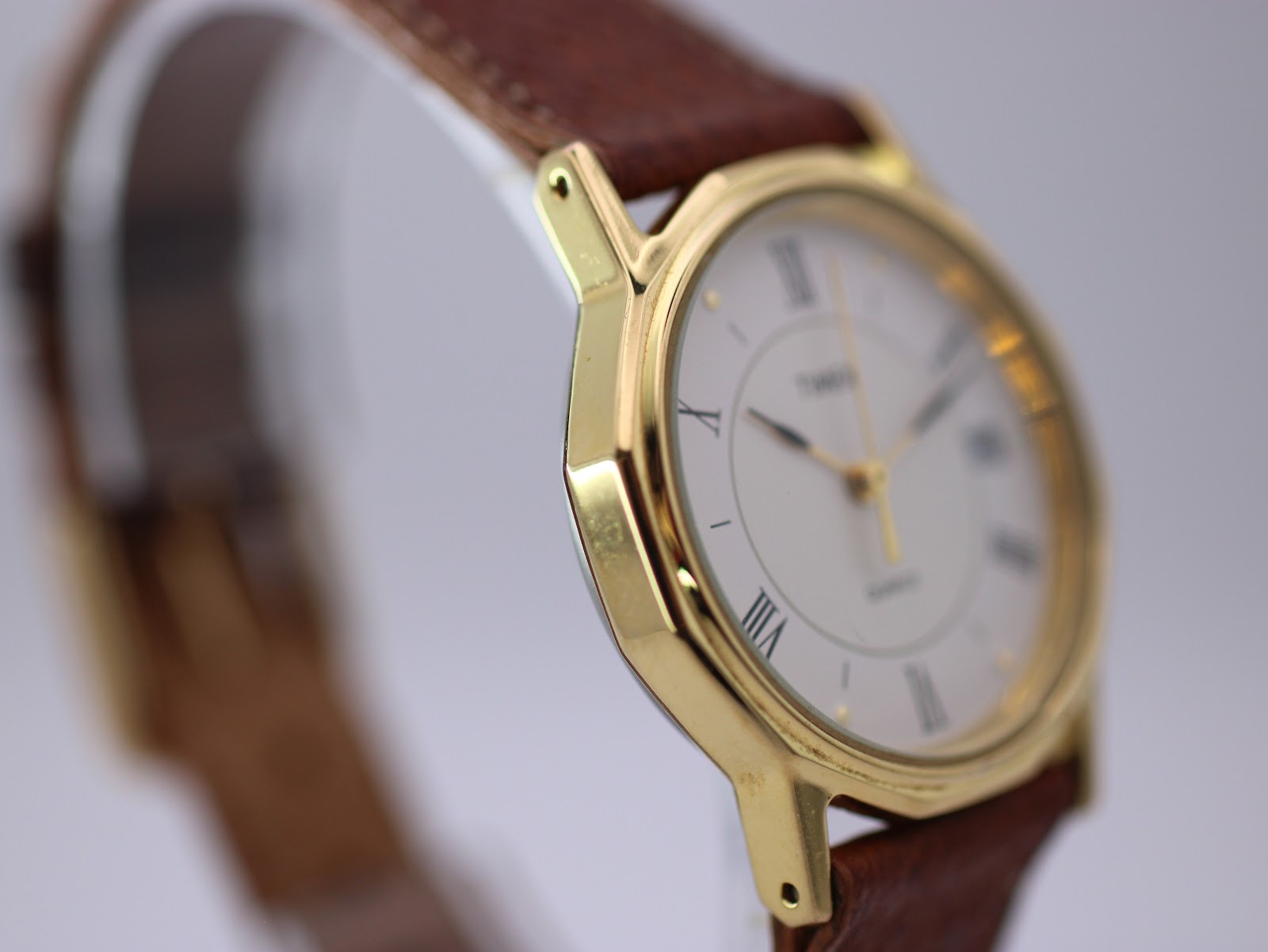 Other side view of the gold-tone Timex watch, highlighting the octagonal case.